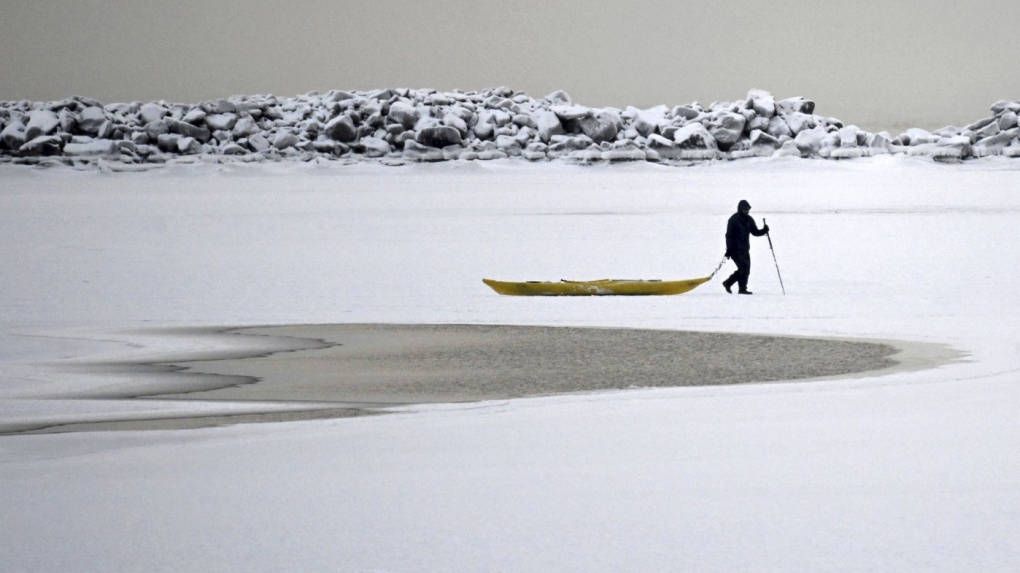 A man walks on the frozen sea in southern Helsinki, Finland, Tuesday, Jan. 2, 2024. (Vesa Moilanen/Lehtikuva via AP)