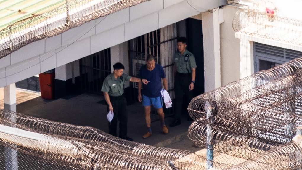 Jimmy Lai, centre, exits his building to go for exercise at the Stanley prison in Hong Kong, Aug. 4, 2023. (AP Photo/Louise Delmotte, File)